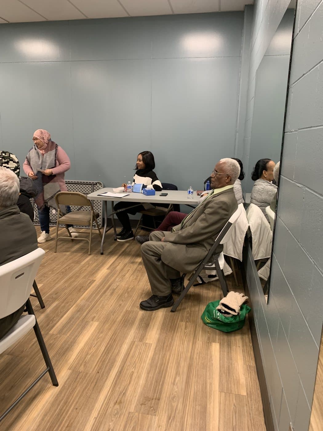 Racialized older adults seated together at a community table